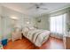 A cozy bedroom featuring light green walls, a comfortable bed, and natural light from the window at 2322 Queenswood Cir, Kissimmee, FL 34743