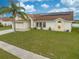 Charming home featuring a well-manicured lawn and a two-car garage at 2322 Queenswood Cir, Kissimmee, FL 34743