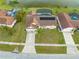 Aerial view of a single-Gathering home with solar panels, screened-in pool, well-maintained lawn, and pond access at 2322 Queenswood Cir, Kissimmee, FL 34743