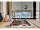 Stainless steel kitchen sink with a window overlooking the screened pool and lake at 2322 Queenswood Cir, Kissimmee, FL 34743