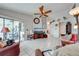 Bright living room featuring tile flooring, a ceiling fan, and sliding doors to the outdoor patio at 2322 Queenswood Cir, Kissimmee, FL 34743