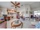 Inviting living room featuring tile flooring, ceiling fan, and ample natural light at 2322 Queenswood Cir, Kissimmee, FL 34743