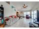 Cozy living room featuring a neutral-toned sofa, a ceiling fan, and sliding glass doors to the lanai at 2322 Queenswood Cir, Kissimmee, FL 34743