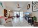 Bright living room featuring neutral decor, a ceiling fan, and sliding glass doors leading to the pool area at 2322 Queenswood Cir, Kissimmee, FL 34743