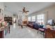 Comfortable living room with tile flooring, a ceiling fan, and large windows for ample natural light at 2322 Queenswood Cir, Kissimmee, FL 34743
