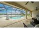 A covered patio offers a tranquil view of the pool, with ample seating for relaxation and entertaining at 2322 Queenswood Cir, Kissimmee, FL 34743