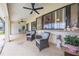 A cozy covered patio features comfortable seating, ceiling fans, and a serene outdoor ambiance at 2322 Queenswood Cir, Kissimmee, FL 34743
