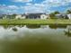 A serene backyard with a peaceful water view, and beautiful lawn space at 2322 Queenswood Cir, Kissimmee, FL 34743