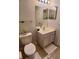 Functional bathroom with a white vanity, toilet, and neutral-toned tiles at 2610 Lodi Cir # 104, Kissimmee, FL 34746