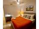 Inviting bedroom featuring a comfortable bed and stylish desk and lamp setup at 2610 Lodi Cir # 104, Kissimmee, FL 34746