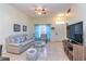 Cozy living room featuring tile floors, comfortable seating, and a front door view at 2610 Lodi Cir # 104, Kissimmee, FL 34746