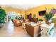 Spacious lounge area furnished with rattan seating, tile flooring, and decorative plants at 2610 Lodi Cir # 104, Kissimmee, FL 34746