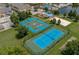 Aerial view of community recreation courts featuring tennis and basketball, surrounded by greenery at 2610 Lodi Cir # 104, Kissimmee, FL 34746