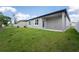 Backyard featuring a covered patio, lush green lawn, and a view of the home's exterior at 2872 Lingo Ln, Orlando, FL 32822