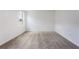 Minimalist bedroom featuring neutral walls, plush carpet, and a single window, creating a peaceful and uncluttered space at 2872 Lingo Ln, Orlando, FL 32822