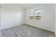 Clean bedroom featuring a large window letting in natural light, neutral walls, and carpet flooring; perfect for relaxation at 2872 Lingo Ln, Orlando, FL 32822