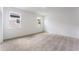 Bright bedroom features neutral decor, two windows providing natural light, and cozy carpet flooring for a welcoming space at 2872 Lingo Ln, Orlando, FL 32822