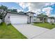 Charming single-story home with a spacious two-car garage and a neatly kept lawn at 2872 Lingo Ln, Orlando, FL 32822