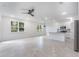 Bright living room featuring an open layout with modern fixtures, tile flooring, and natural light from surrounding windows at 2872 Lingo Ln, Orlando, FL 32822