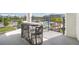 A cozy outdoor balcony features patio furniture overlooking palm trees and the community pool at 3120 Paradox Cir # 302, Kissimmee, FL 34746