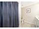 Cozy bathroom featuring a shower with a blue curtain and a single sink at 3120 Paradox Cir # 302, Kissimmee, FL 34746