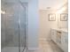 Modern bathroom with a glass-enclosed shower and a vanity with storage and double sinks at 3120 Paradox Cir # 302, Kissimmee, FL 34746
