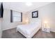 A cozy bedroom features a queen bed with fresh linens, bedside tables and a window with blinds at 3120 Paradox Cir # 302, Kissimmee, FL 34746