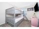 A playful bedroom showcasing a sturdy bunk bed with a ladder, alongside a pink nightstand at 3120 Paradox Cir # 302, Kissimmee, FL 34746