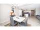 Dining area that connects to a sleek, modern kitchen with ample seating and natural light at 3120 Paradox Cir # 302, Kissimmee, FL 34746