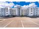 Apartment building showcasing a modern design with white and gray accents against a bright blue sky at 3120 Paradox Cir # 302, Kissimmee, FL 34746