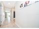 Well-lit hallway featuring neutral tones, tile flooring, and decorative wall art at 3120 Paradox Cir # 302, Kissimmee, FL 34746