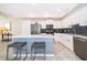 Modern kitchen with white cabinets, stainless steel appliances, and a center island with seating at 3120 Paradox Cir # 302, Kissimmee, FL 34746