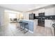 A modern kitchen and dining area boasts stainless steel appliances, a central island and bar stool seating at 3120 Paradox Cir # 302, Kissimmee, FL 34746