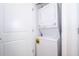 Efficient laundry closet with a stacked washer and dryer unit for convenient laundry needs at 3120 Paradox Cir # 302, Kissimmee, FL 34746