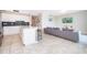 Open-concept kitchen and living area featuring modern appliances and a comfortable sofa at 3120 Paradox Cir # 302, Kissimmee, FL 34746