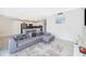 Open-concept living area showcasing a comfortable gray sectional sofa and a modern kitchen at 3120 Paradox Cir # 302, Kissimmee, FL 34746