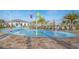Community splash pad with colorful water features, palm trees, and lounge chairs at 3120 Paradox Cir # 302, Kissimmee, FL 34746