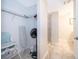 Spacious walk-in closet with shelving, an ironing board, and access to the bathroom at 3120 Paradox Cir # 302, Kissimmee, FL 34746