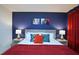 Charming bedroom with vibrant blue walls, colorful Marvel-themed decor, and comfortable furnishings at 4213 Paragprah St, Kissimmee, FL 34746