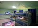 Fun bedroom featuring triple bunk beds with a playful Mario themed rug at 4213 Paragprah St, Kissimmee, FL 34746