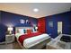 Comfortable bedroom featuring blue walls, fun artwork, and a well-lit space at 4213 Paragprah St, Kissimmee, FL 34746