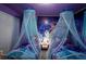 Charming bedroom with twin beds featuring Frozen artwork and canopies at 4213 Paragprah St, Kissimmee, FL 34746