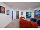 Spacious carpeted game room with a comfortable red sofa, a tv and doorways to other rooms at 4213 Paragprah St, Kissimmee, FL 34746