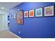 Hallway with vivid blue walls and framed Marvel superhero themed art at 4213 Paragprah St, Kissimmee, FL 34746