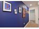 Stylish hallway with deep blue walls adorned with pop art and well-lit neutral carpeting at 4213 Paragprah St, Kissimmee, FL 34746