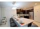 Modern kitchen with a large island featuring seating, dark cabinets and stainless steel appliances at 4213 Paragprah St, Kissimmee, FL 34746
