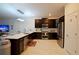 Modern kitchen with stainless steel appliances, dark cabinetry, and white countertops at 4213 Paragprah St, Kissimmee, FL 34746