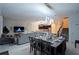 Open-concept living area with views of the kitchen, dining area, and staircase to the second floor at 4213 Paragprah St, Kissimmee, FL 34746