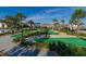 Community miniature golf course with palm trees, landscaping and covered tiki hut at 4213 Paragprah St, Kissimmee, FL 34746