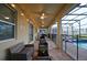 Outdoor patio area featuring furniture, string lights, ceiling fans, and screened-in pool at 4213 Paragprah St, Kissimmee, FL 34746